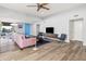 Living area with hardwood floors, pink sofa, and a view of the kitchen at 8634 E Monterosa Ave, Scottsdale, AZ 85251