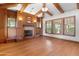 Living room with hardwood floors, a fireplace, and large windows at 13118 N Founders Park Blvd, Surprise, AZ 85379