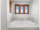 Relaxing bathtub with three windows above at 13118 N Founders Park Blvd, Surprise, AZ 85379