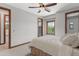 Bedroom with a queen bed, ceiling fan and large window at 13118 N Founders Park Blvd, Surprise, AZ 85379