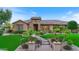 Stunning curb appeal with lush landscaping, a brick pathway and palm trees at 7054 E Ingram St, Mesa, AZ 85207