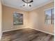 Bright bedroom with wood-look floors and large window at 7054 E Ingram St, Mesa, AZ 85207