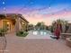 Relaxing backyard with a sparkling pool and string lights at 7054 E Ingram St, Mesa, AZ 85207