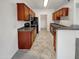 Kitchen with wood cabinets, granite counters and black appliances at 17017 N 12Th St # 2124, Phoenix, AZ 85022