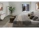 Main bedroom with large window, staged furniture, and carpeting at 17017 N 12Th St # 2124, Phoenix, AZ 85022