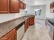 Well-equipped kitchen featuring dark wood cabinets and tile flooring at 17017 N 12Th St # 2124, Phoenix, AZ 85022