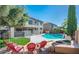 Spacious backyard with a kidney-shaped pool, fire pit, and comfortable seating at 17473 W Elizabeth Ave, Goodyear, AZ 85338
