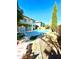 Relaxing backyard with a refreshing pool, fire pit, and plenty of space for entertaining at 17473 W Elizabeth Ave, Goodyear, AZ 85338