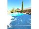 Inviting backyard pool with a spacious concrete patio and fire pit area at 17473 W Elizabeth Ave, Goodyear, AZ 85338