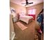 Charming bedroom with ceiling fan and pink accents at 17473 W Elizabeth Ave, Goodyear, AZ 85338
