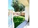 Artificial turf backyard with a tree and pink chairs at 17473 W Elizabeth Ave, Goodyear, AZ 85338