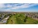 Aerial view of a neighborhood near a golf course and lake at 10802 W Cameo Dr, Sun City, AZ 85351