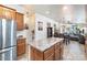 Open kitchen features an island, stainless steel appliances, and views into adjacent living areas at 8865 E Baseline Rd # 128, Mesa, AZ 85209