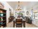Dining area with chandelier and view to the living room at 8865 E Baseline Rd # 128, Mesa, AZ 85209