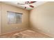 Sunny bedroom with ceiling fan and window at 13820 W Cheery Lynn Rd, Avondale, AZ 85392
