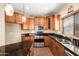 Modern kitchen with wood cabinets, granite countertops, and stainless steel appliances at 13820 W Cheery Lynn Rd, Avondale, AZ 85392