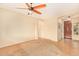 Living room features a ceiling fan and views of the entry and kitchen at 13820 W Cheery Lynn Rd, Avondale, AZ 85392