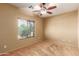 Well-lit bedroom with ceiling fan and window at 13820 W Cheery Lynn Rd, Avondale, AZ 85392