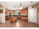 Open kitchen with island, wood cabinets, granite counters and stainless steel appliances at 13820 W Cheery Lynn Rd, Avondale, AZ 85392