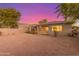 Backyard view of home with sunset in background at 13820 W Cheery Lynn Rd, Avondale, AZ 85392