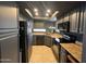 Modern kitchen with dark gray cabinets and granite countertops at 10015 E Mountain View Rd # 2011, Scottsdale, AZ 85258