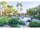 Serene community landscape with a pond, lush greenery, and walking paths at 10015 E Mountain View Rd # 2011, Scottsdale, AZ 85258