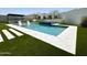 Inviting rectangular pool with a spa and outdoor kitchen area at 27222 N 64Th Dr, Phoenix, AZ 85083