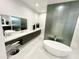 Modern bathroom with a freestanding tub and sleek double vanity at 27222 N 64Th Dr, Phoenix, AZ 85083
