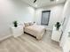 Light and airy bedroom with queen bed and wood floors at 27222 N 64Th Dr, Phoenix, AZ 85083