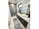 Modern bathroom with double sinks and a large walk-in shower at 27222 N 64Th Dr, Phoenix, AZ 85083