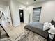 Bright bedroom with a queen bed, walk-in closet, and light wood floors at 27222 N 64Th Dr, Phoenix, AZ 85083