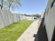 Artificial turf backyard with a basketball court and walkway at 27222 N 64Th Dr, Phoenix, AZ 85083