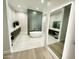 Spa-like bathroom featuring a freestanding tub and a large mirror at 27222 N 64Th Dr, Phoenix, AZ 85083