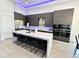 Gourmet kitchen boasts modern cabinetry, a large island with seating, and high-end appliances at 27222 N 64Th Dr, Phoenix, AZ 85083