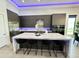 Modern kitchen with large island, white quartz countertops, and dark grey cabinetry at 27222 N 64Th Dr, Phoenix, AZ 85083