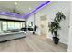 Spacious living room featuring hardwood floors, a modern fireplace, and sliding glass doors leading to the backyard at 27222 N 64Th Dr, Phoenix, AZ 85083