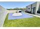 Private backyard basketball court with artificial turf and surrounding landscaping at 27222 N 64Th Dr, Phoenix, AZ 85083