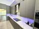 Modern kitchen with sleek grey cabinets, quartz countertops, and a gas cooktop at 27222 N 64Th Dr, Phoenix, AZ 85083