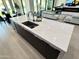 Kitchen island with white quartz countertop and sink at 27222 N 64Th Dr, Phoenix, AZ 85083