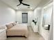 Bright bedroom with a queen bed, dresser, and ensuite bathroom at 27222 N 64Th Dr, Phoenix, AZ 85083