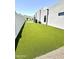 Artificial turf backyard with putting green and privacy wall at 27222 N 64Th Dr, Phoenix, AZ 85083