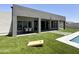 Artificial turf backyard with a modern home and a cornhole game at 27222 N 64Th Dr, Phoenix, AZ 85083