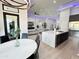 Open concept kitchen with island, white quartz countertops, and modern cabinetry at 27222 N 64Th Dr, Phoenix, AZ 85083