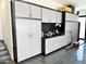 Garage with extensive storage cabinets and work area at 27222 N 64Th Dr, Phoenix, AZ 85083