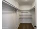 Large walk-in closet with shelving and hanging rods at 7417 N Via Camello Del Norte -- # 160, Scottsdale, AZ 85258
