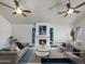 Bright living room with a fireplace, two ceiling fans, and staged furniture at 7417 N Via Camello Del Norte -- # 160, Scottsdale, AZ 85258