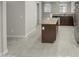 Open kitchen with an island, granite countertops, and tile flooring at 2150 W Alameda Rd # 1250, Phoenix, AZ 85085