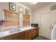 Laundry room with sink, cabinets, and microwave at 43908 N 10Th St, New River, AZ 85087