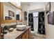 Bathroom with contemporary sink, wood cabinets, and patterned shower curtain at 43908 N 10Th St, New River, AZ 85087