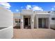 Front entrance of a stucco home with a courtyard and brick walkway at 43908 N 10Th St, New River, AZ 85087